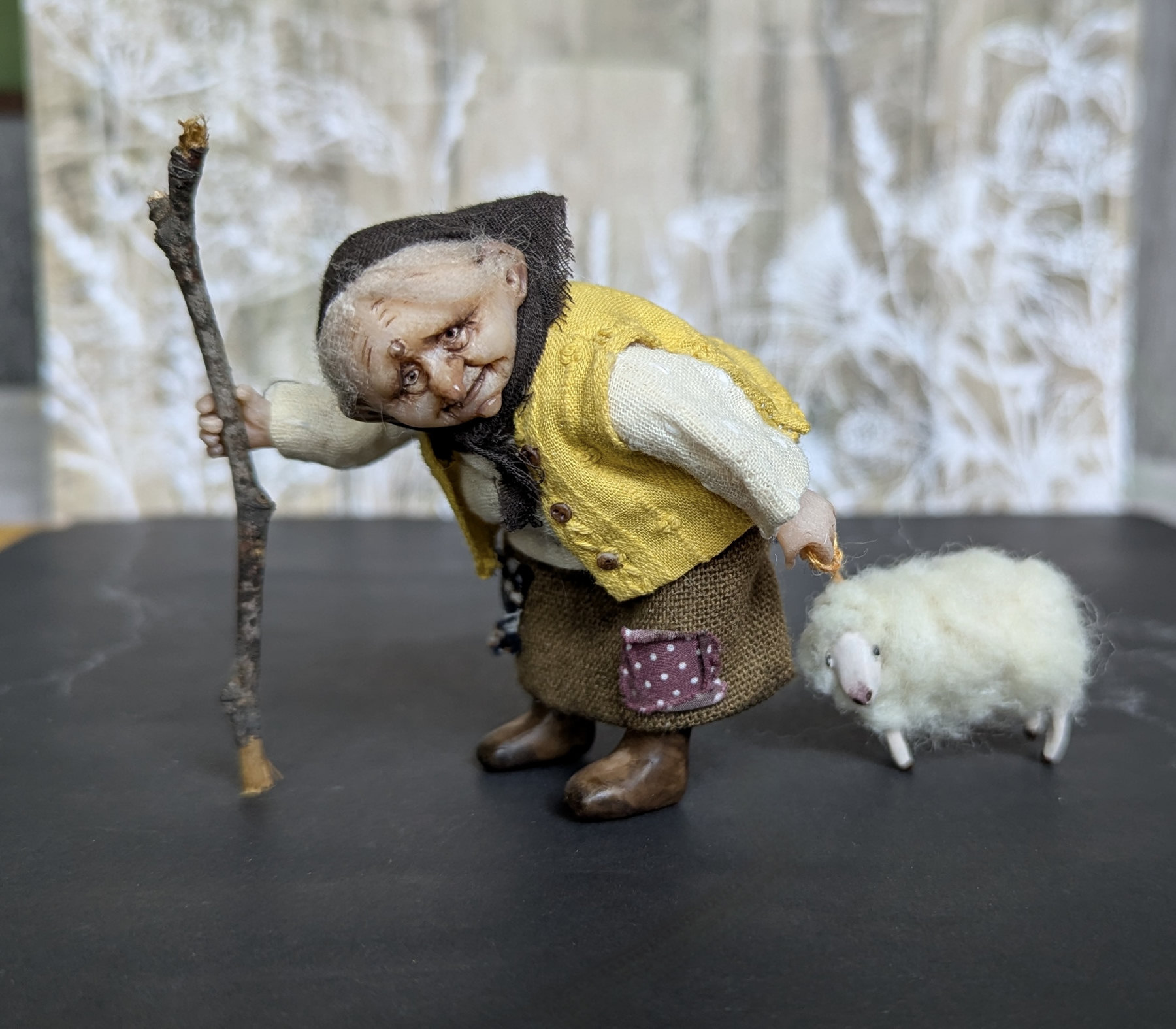 Small doll Granny with her sheep