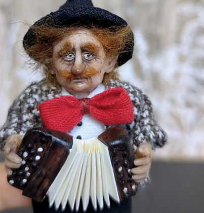 Close-up detail of a handmade gothic miniature — Small art doll Street Musician, one-of-a-kind sculpture by Ritunia