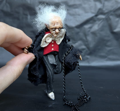 Close-up detail of a handmade gothic miniature — Small doll Vampire, Acrylic paint, polymer clay, fabric