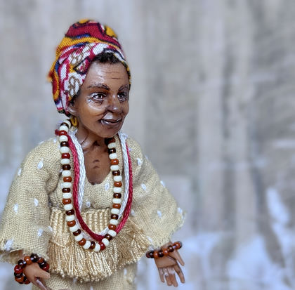 Close-up detail of a handmade gothic miniature — Small art doll Black Woman with basket