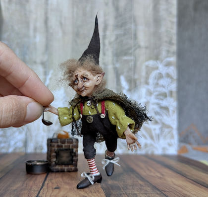Close-up detail of a handmade gothic miniature — Small art doll Cooking gnome, Acrylic paint, polymer clay, fabric, wool