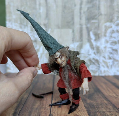 Close-up detail of a handmade gothic miniature — Small art doll Gnome