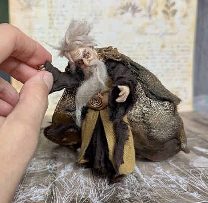 Close-up detail of a handmade gothic miniature — Small art doll Wizard